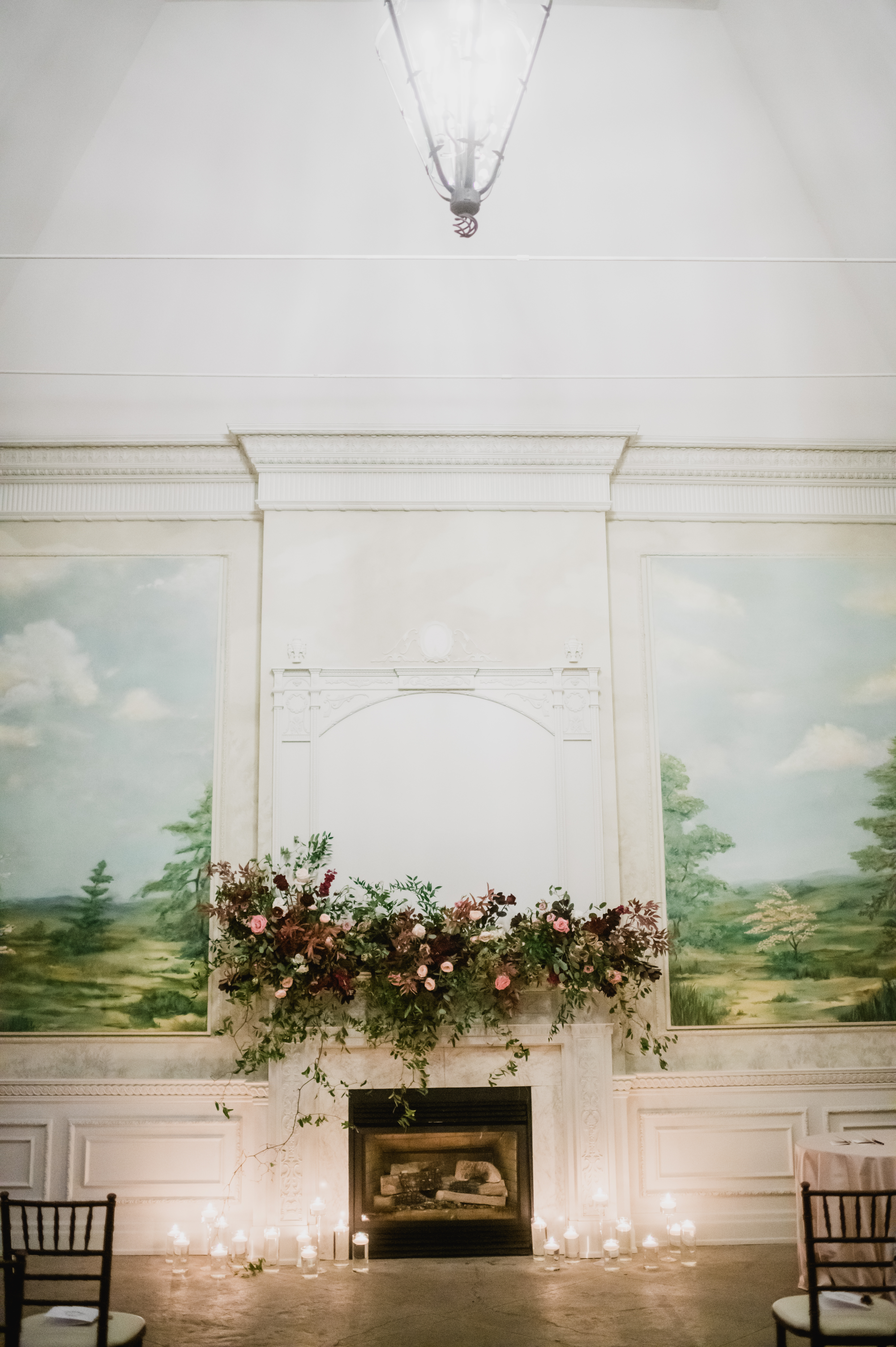 Florals decorate a mantel in a Toronto wedding venue