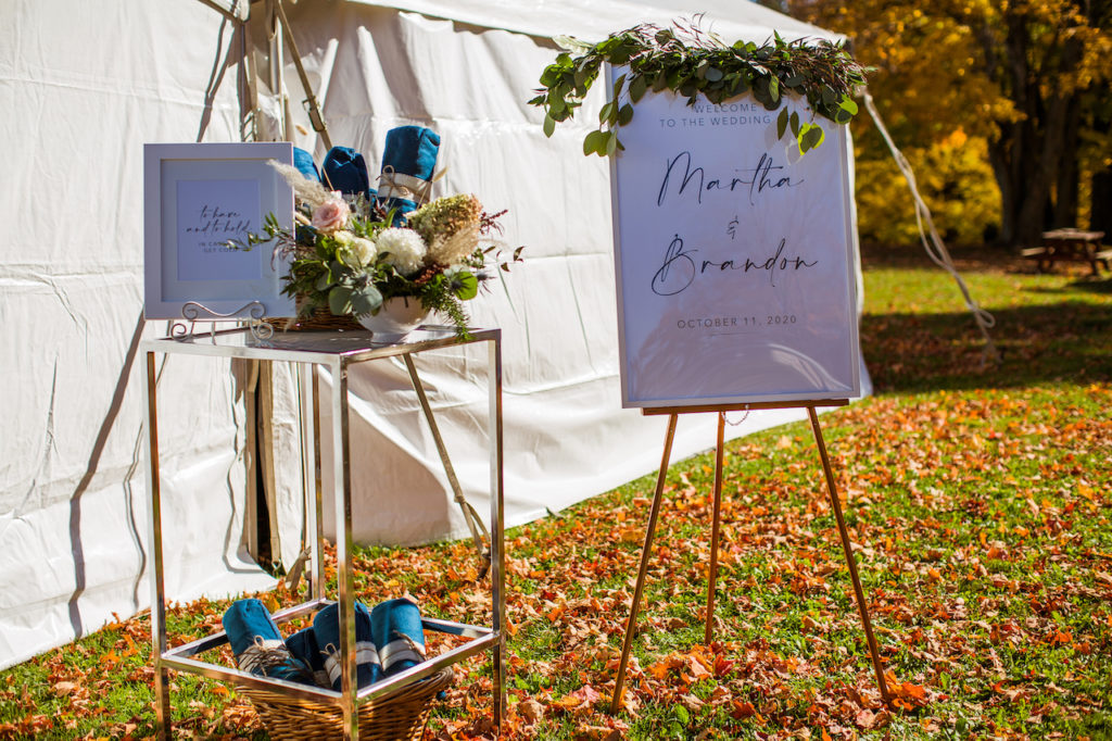 Autumn wedding theme reception signage stands outside the reception tent at Fermanagh Farms