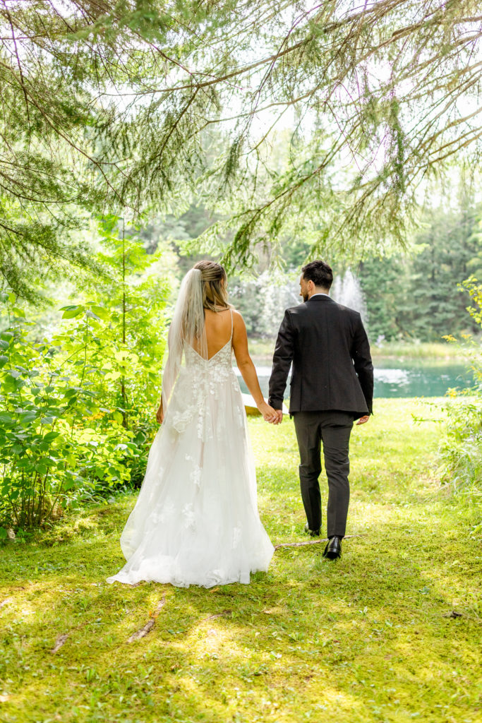 Bride and Groom Walk Hand in Hand At their Outdoor Wedding in Toronto