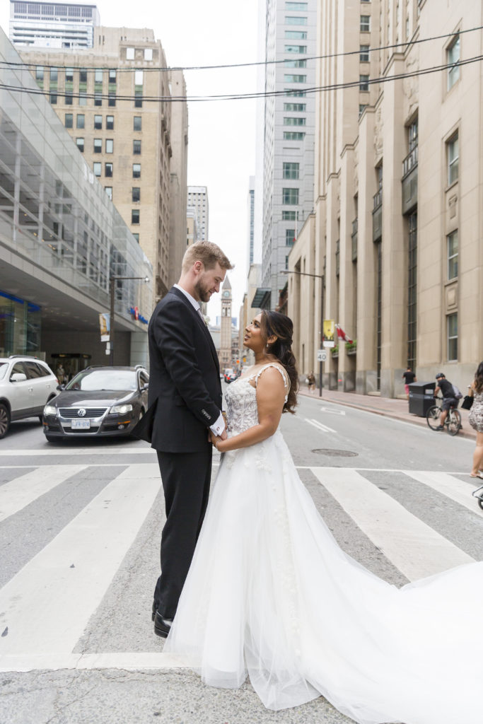 A couple stand in downtown Toronto for their wedding portraits