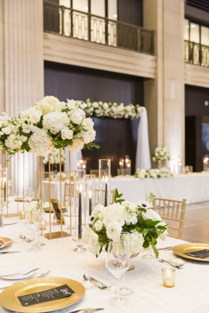 Beautiful floral centerpieces are set around reception tables at a One King West wedding